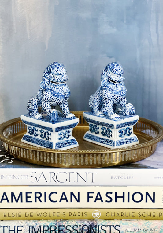 blue and white foo dog set on a vintage brass serving tray
