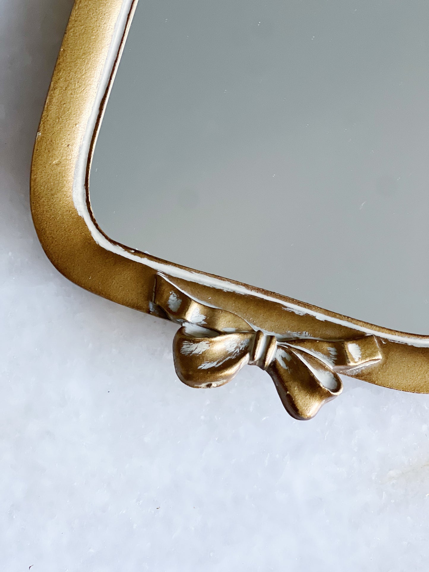 Small gold bow mirror