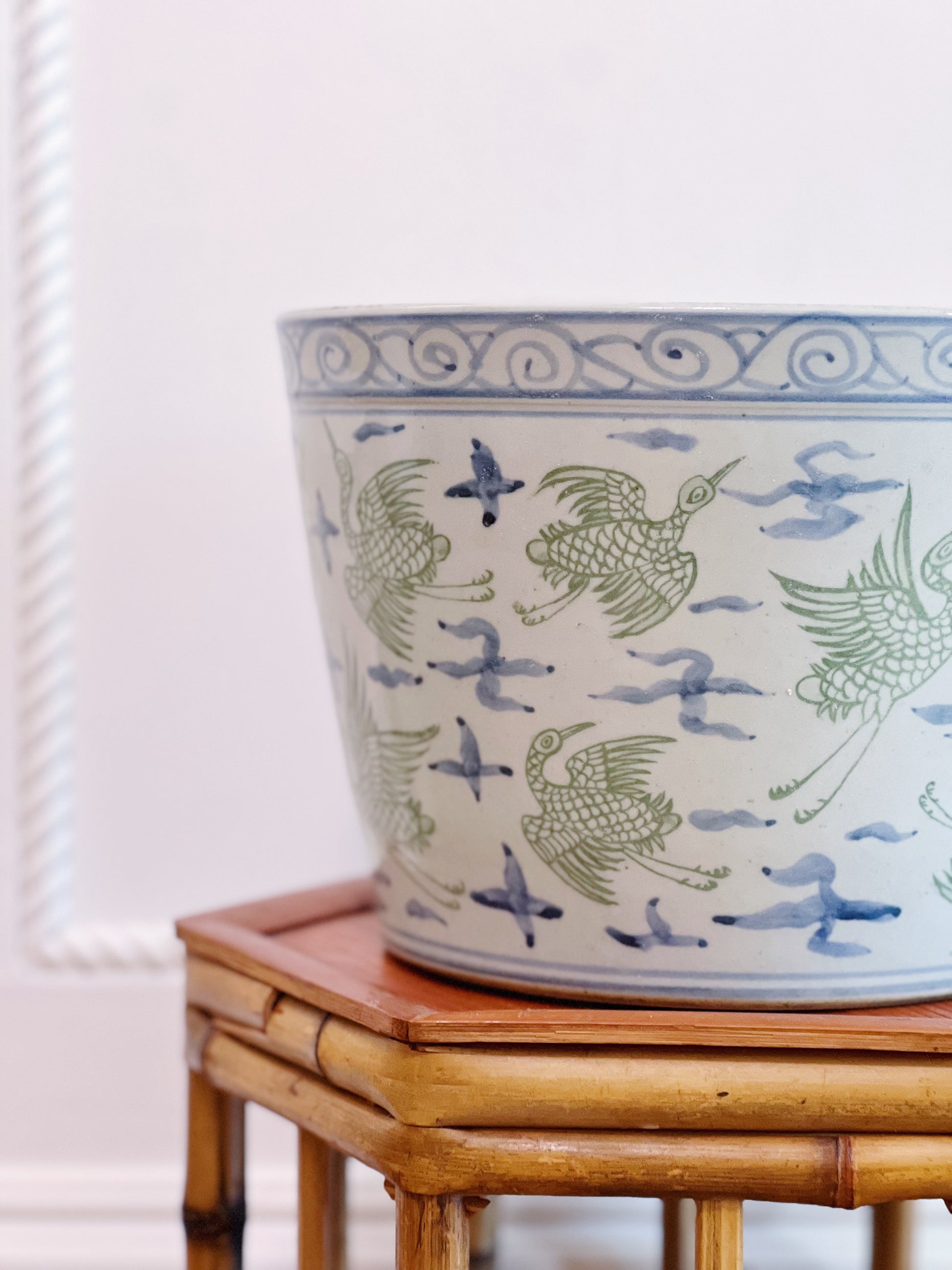 Green and blue crane porcelain planter on vintage bamboo plant stand 