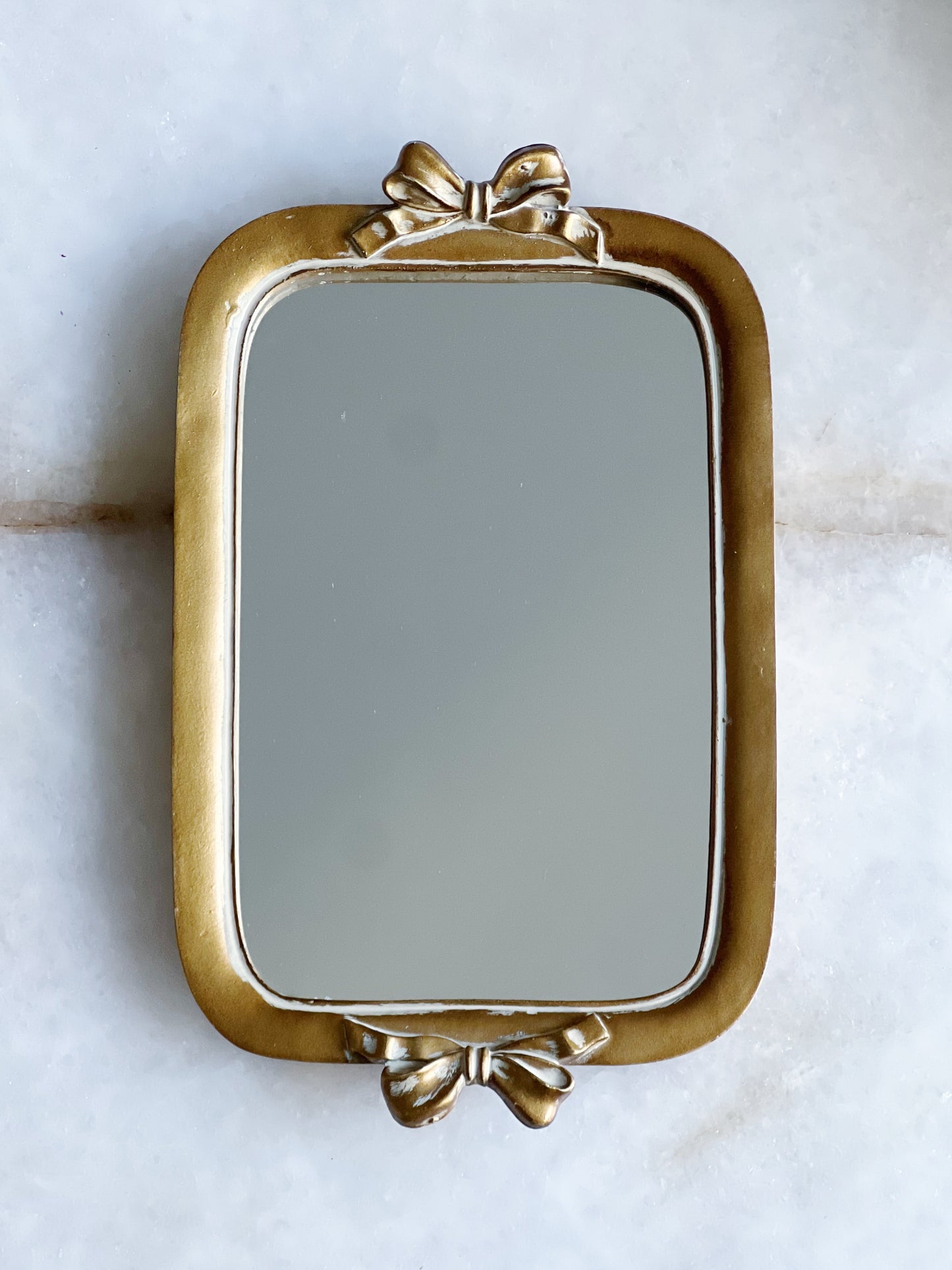 Small gold bow mirror