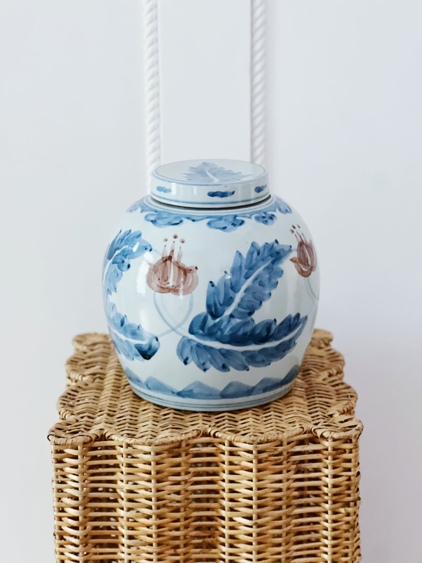 Blue and white ginger jar on a wicker pedestal 