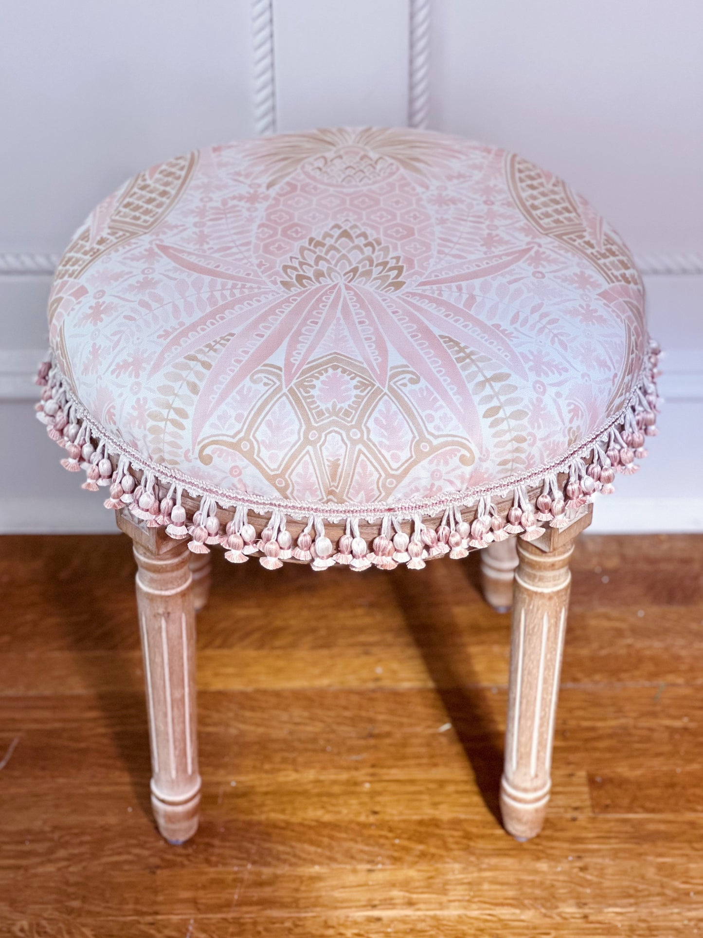 Vanity stool upholstered in custom fabric Schumacher cap Ferrat and scalamandre tassel trim 