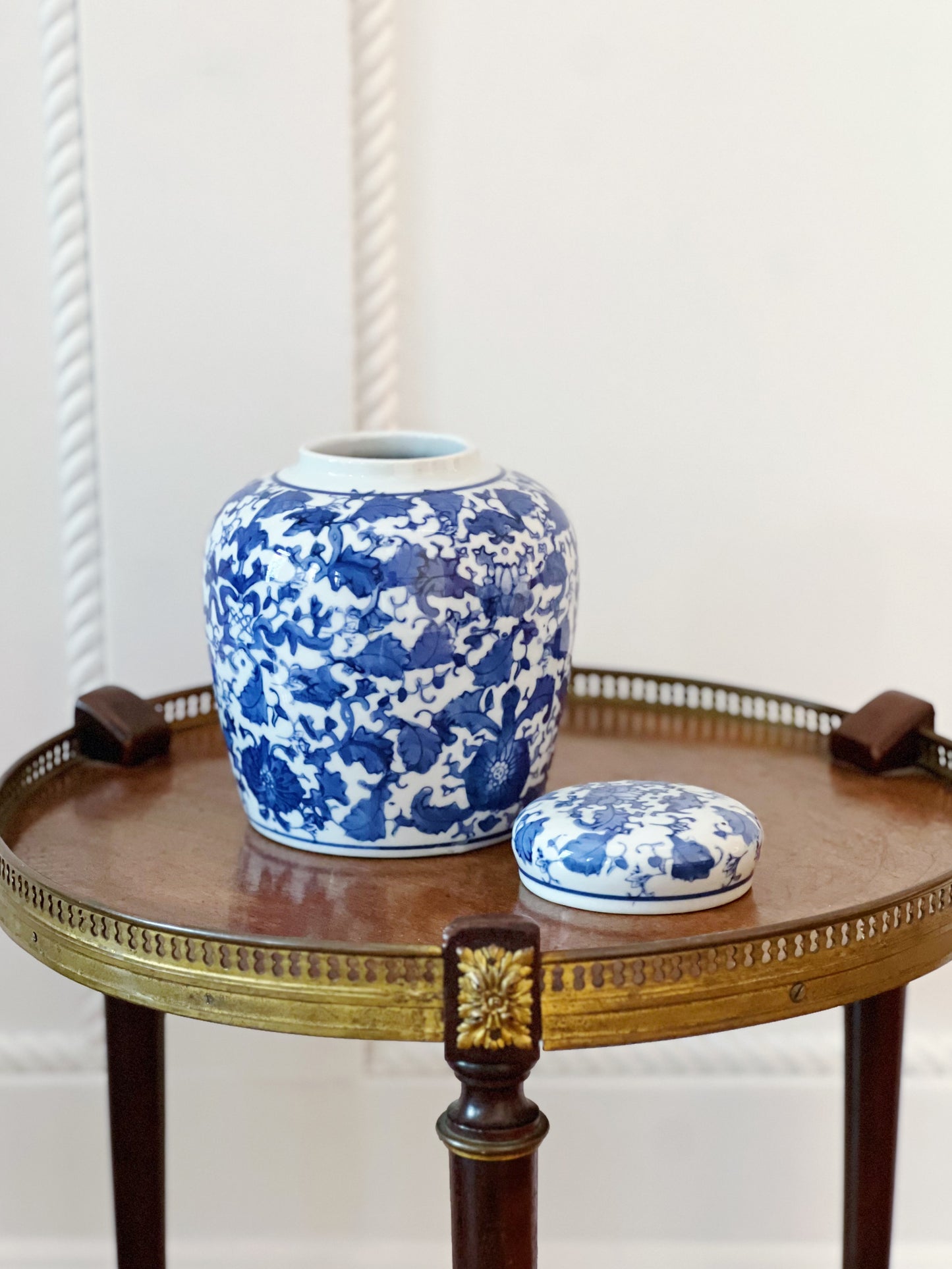 scrolling peonies blue and white ginger jar with lid off on wooden table