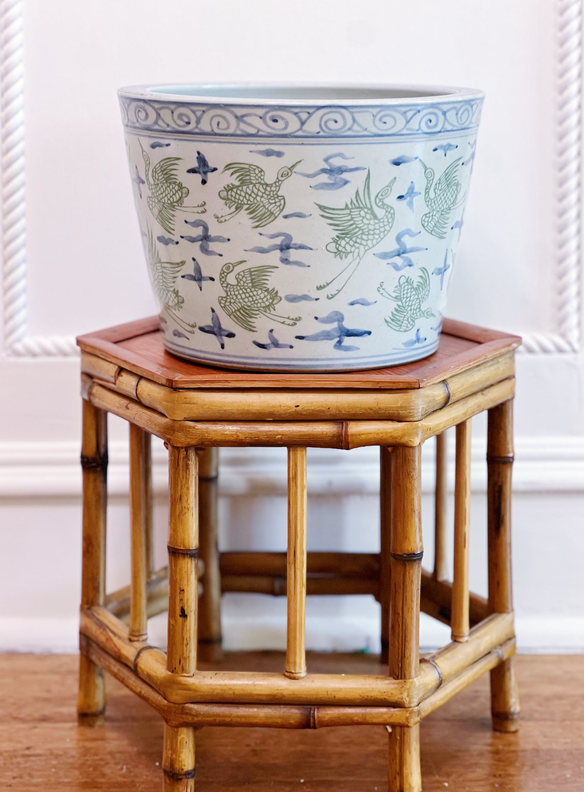 Green and blue crane porcelain planter on vintage bamboo plant stand 