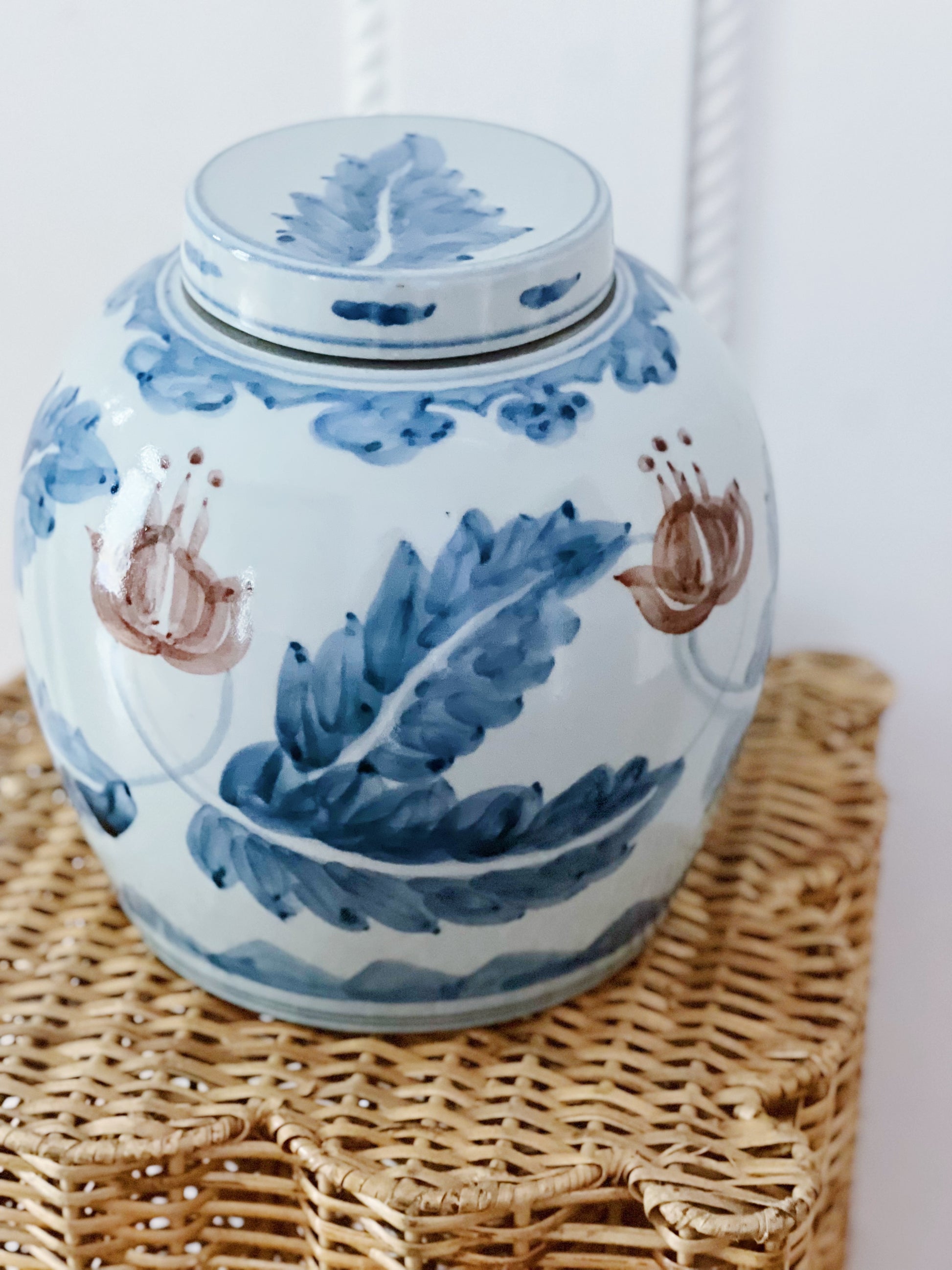 Blue and white ginger jar on a wicker pedestal 