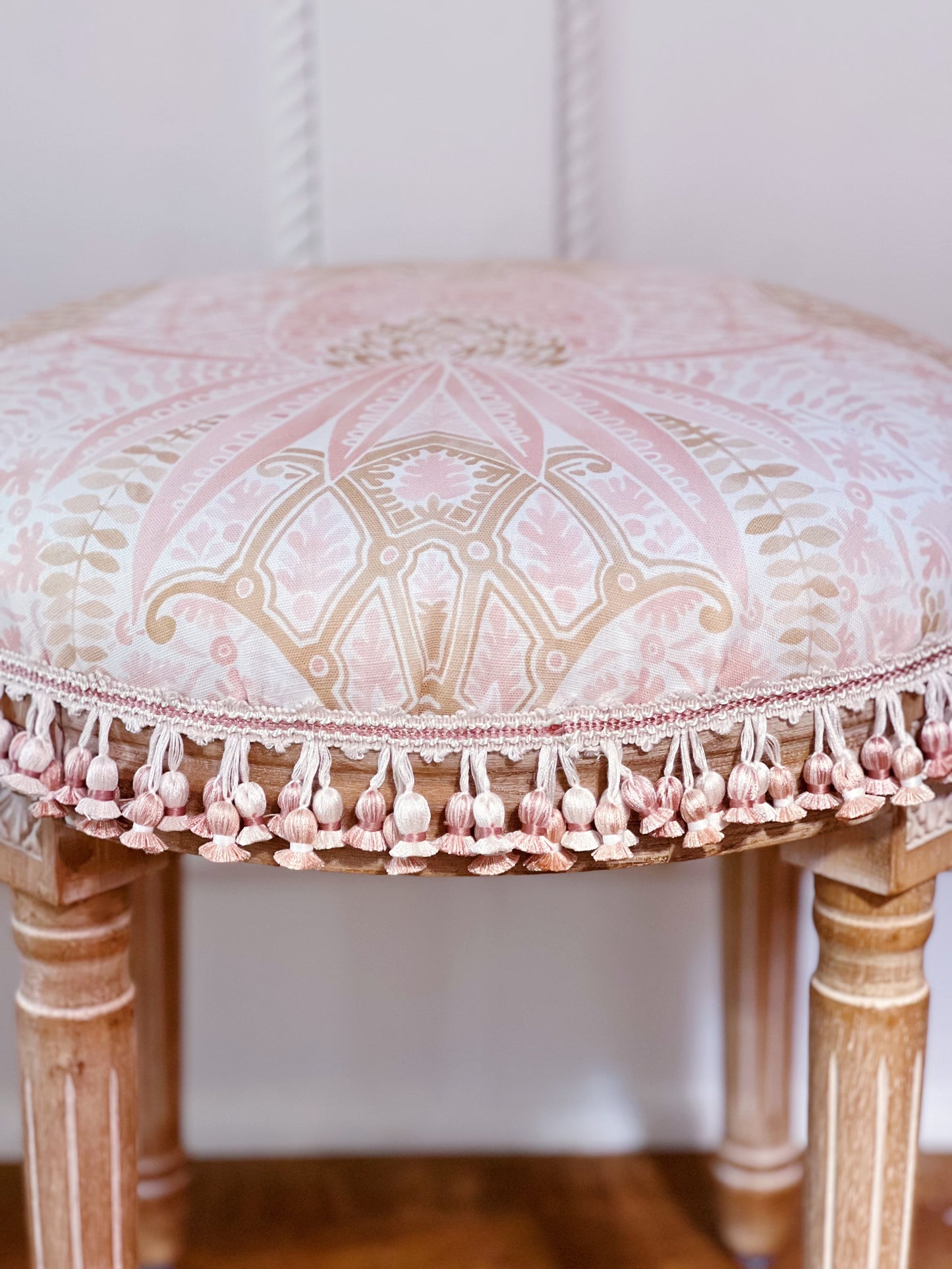 Vanity stool upholstered in custom fabric Schumacher cap Ferrat and scalamandre tassel trim 