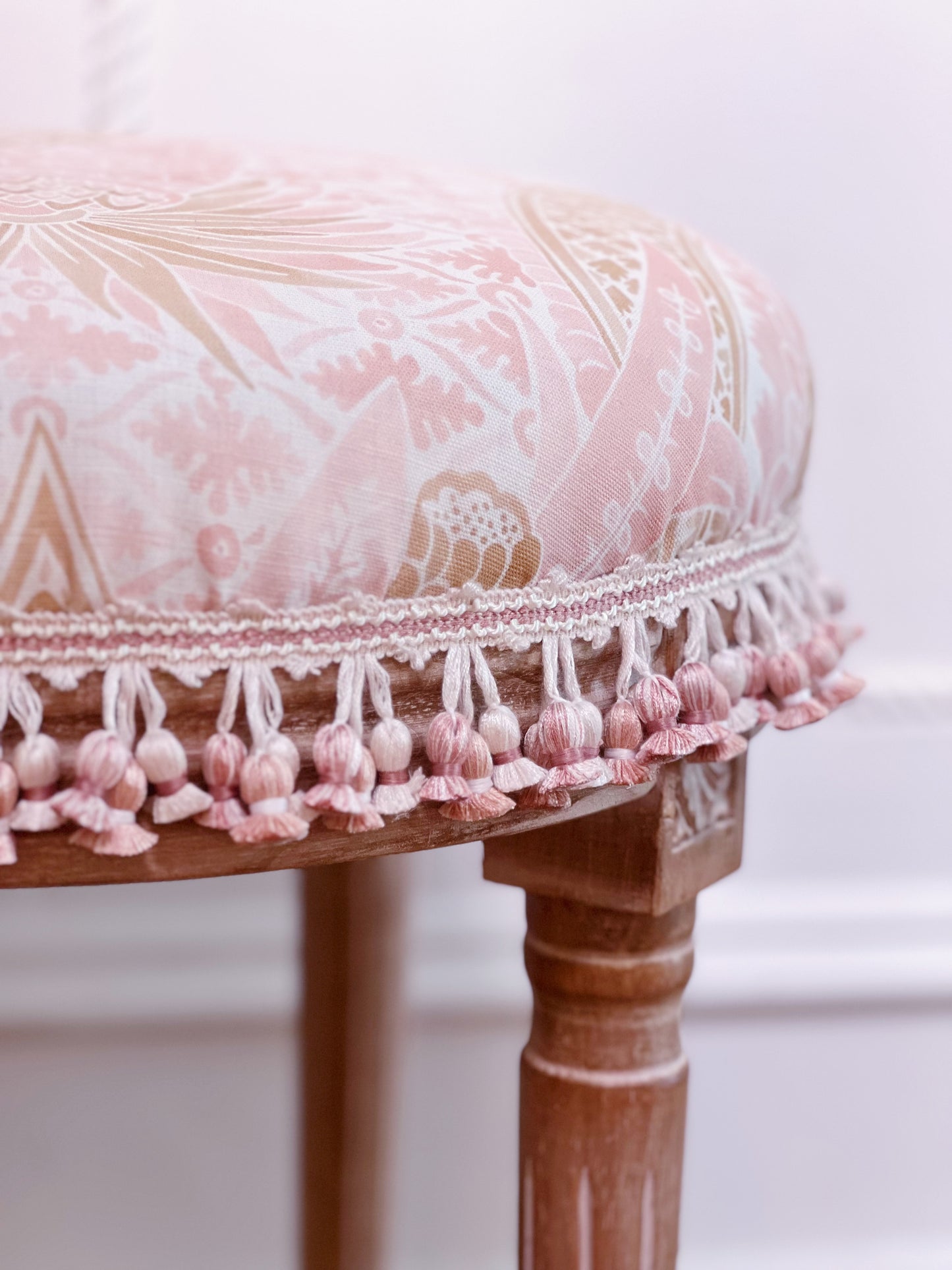 Vanity stool upholstered in custom fabric Schumacher cap Ferrat and scalamandre tassel trim 