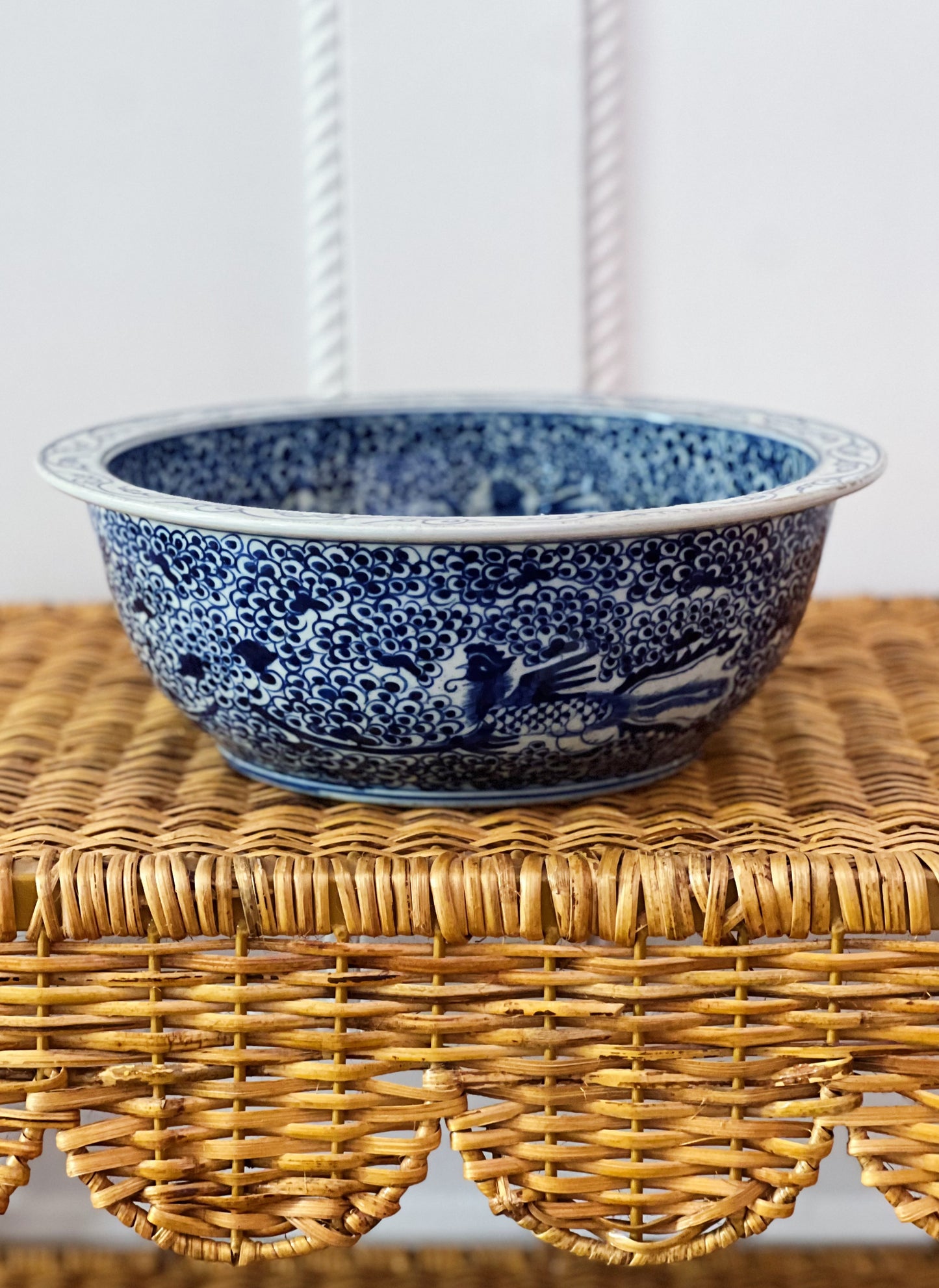 blue and white basin bowl on a wicker shelf