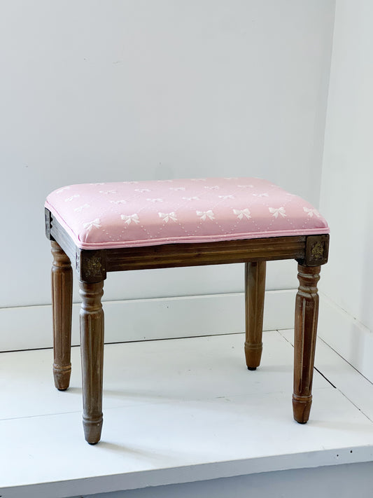 vintage bench recovered in pink bow fabric 