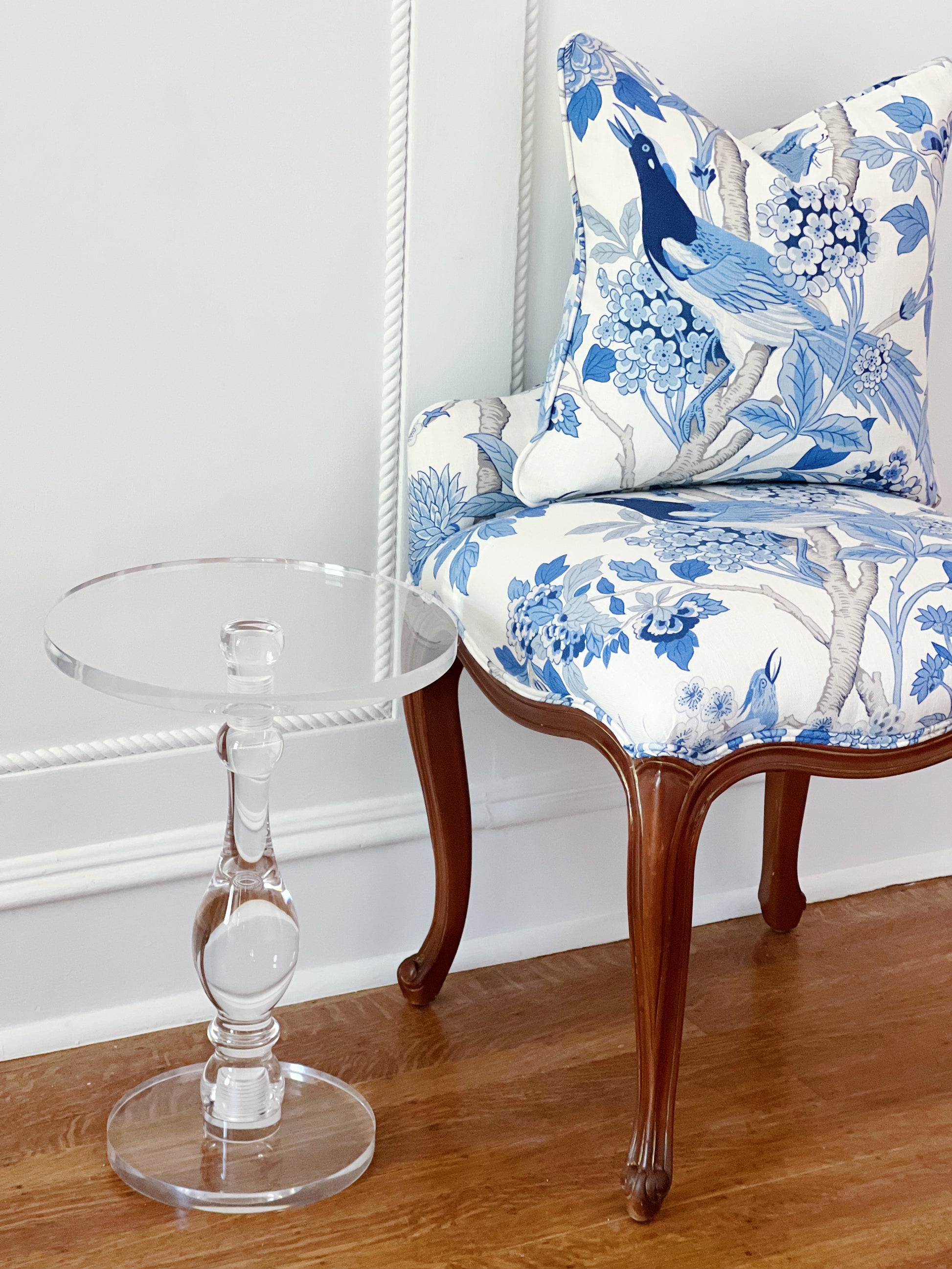 Ritz Carlton New Orleans vintage furniture vanity stool covered in GP & J Baker in Hydrangea Blue and matching custom pillow next to an acrylic side table 